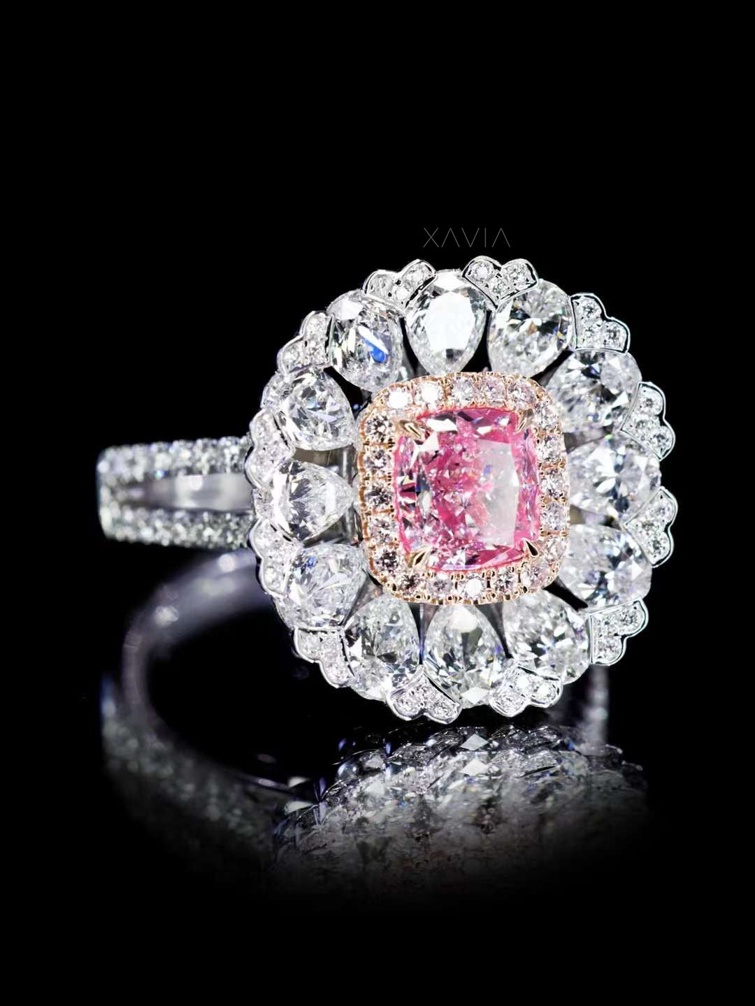 angled side profile of pink cushion cut diamond ring with floral white diamond halo and pavé split shank